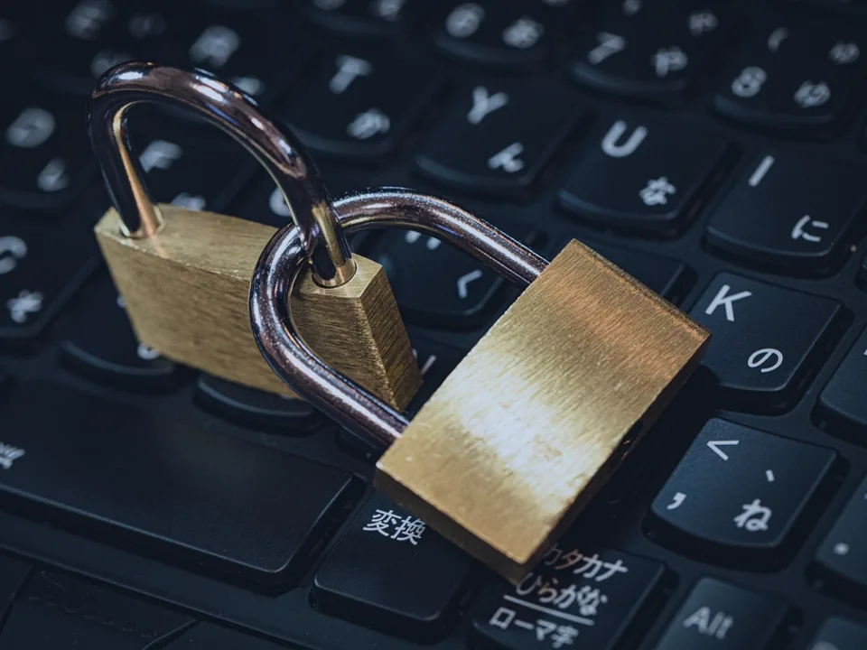 Padlock resting on a keyboard for access and security controls