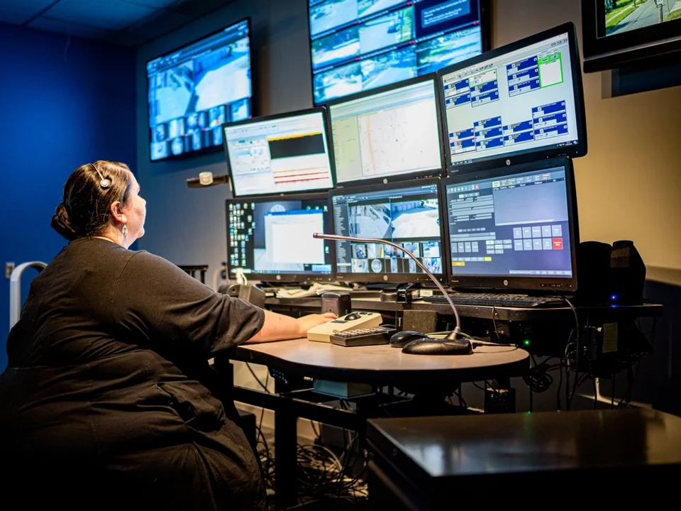 Operator watching a wall of monitoring screens